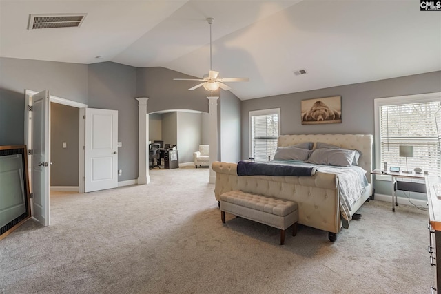 carpeted bedroom featuring high vaulted ceiling, multiple windows, ceiling fan, and decorative columns