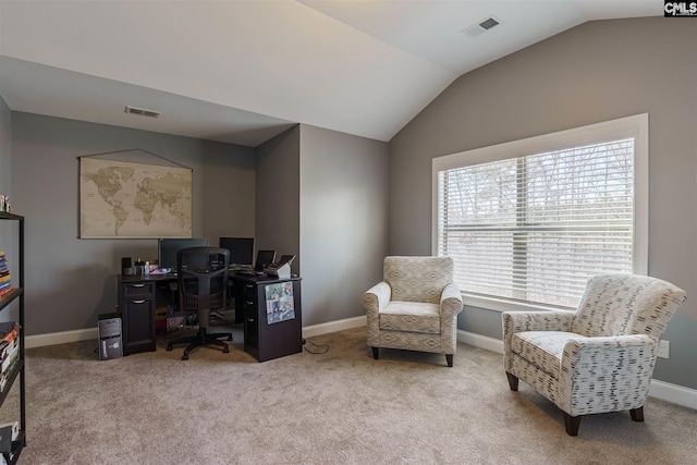 office space featuring light colored carpet and vaulted ceiling