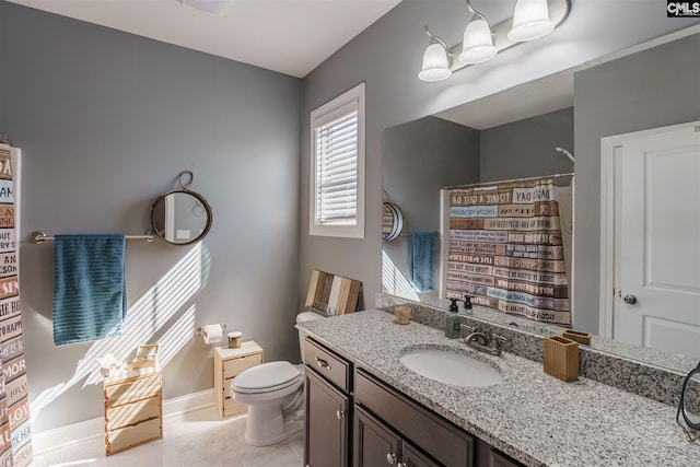 bathroom featuring toilet, tile floors, and vanity