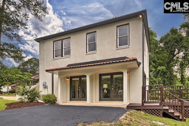 back of property with a wooden deck