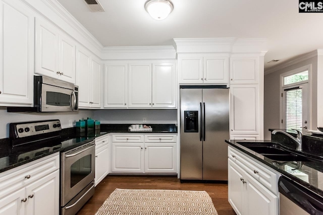 kitchen with dark hardwood / wood-style flooring, white cabinets, stainless steel appliances, and sink