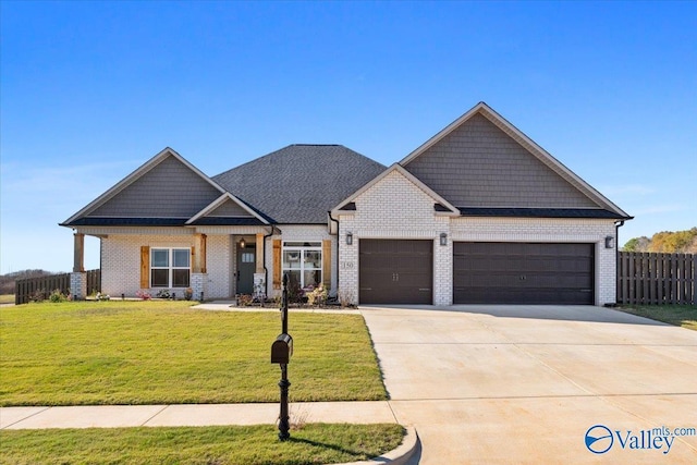 craftsman-style house with a front yard and a garage