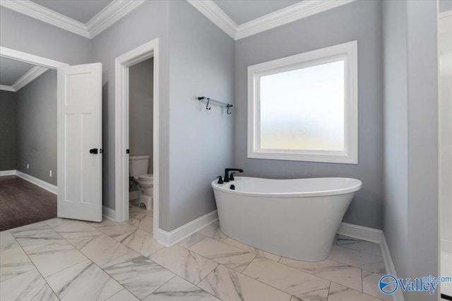 bathroom with crown molding, a bath, and toilet