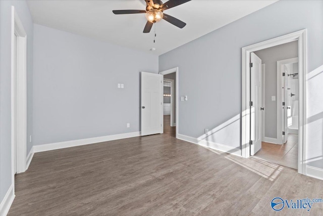 empty room featuring ceiling fan and dark wood-type flooring