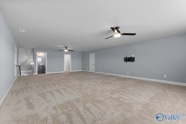 carpeted spare room with ceiling fan