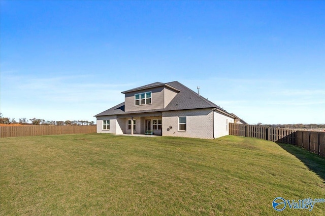 back of property featuring a lawn and a patio