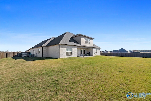 rear view of property with a lawn