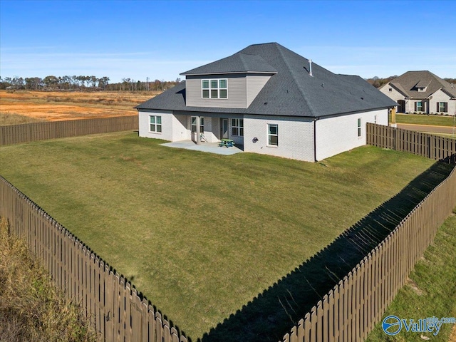 rear view of house with a lawn and a patio area