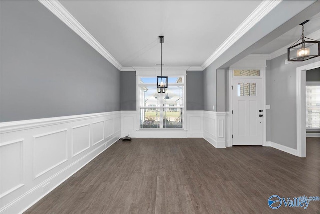 unfurnished dining area featuring a notable chandelier, dark hardwood / wood-style floors, a healthy amount of sunlight, and crown molding