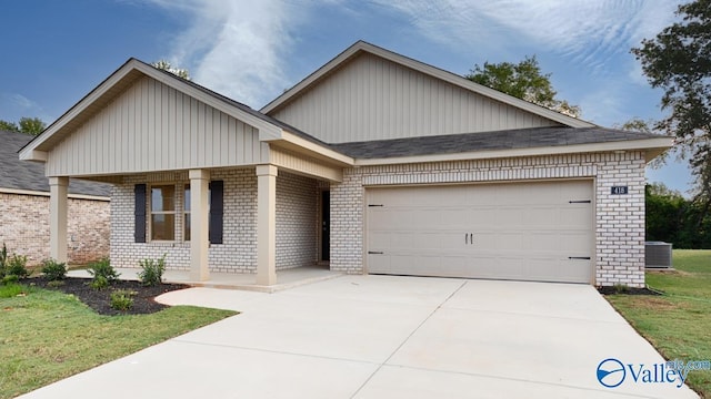 view of front of house with brick siding, covered porch, driveway, and a garage