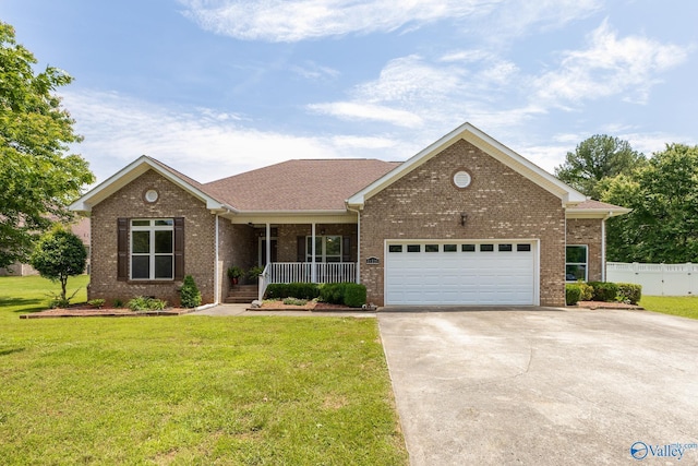11228 Stewart Rd, Tanner, AL 35671 - view of front of house with a porch, driveway, a garage, and brick siding