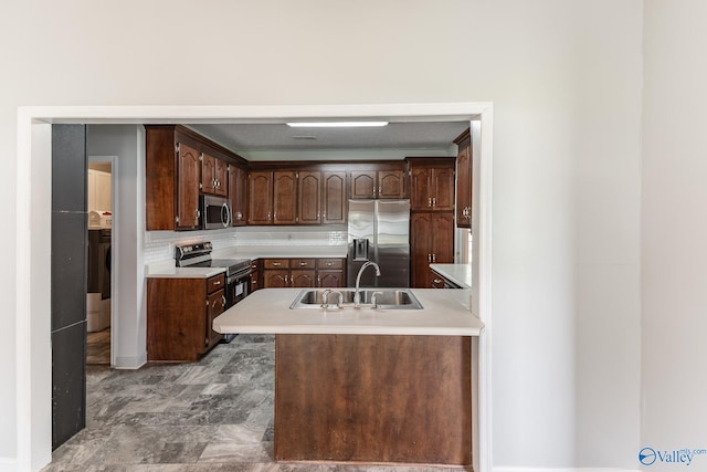 11228 Stewart Rd, Tanner, AL 35671 - kitchen with appliances with stainless steel finishes, a sink, light countertops, backsplash, and a peninsula