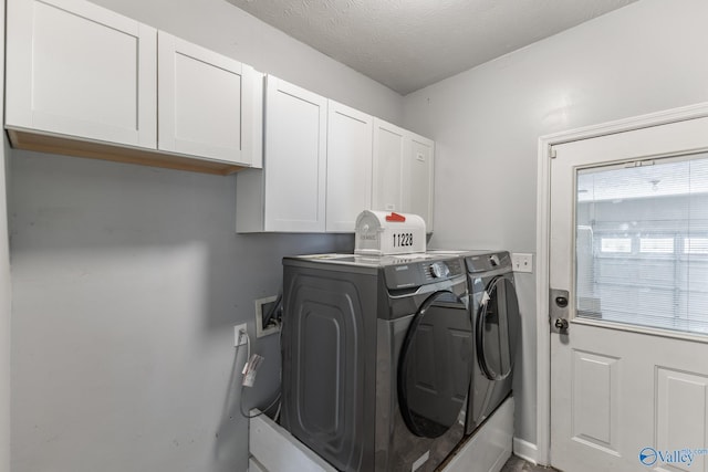 11228 Stewart Rd, Tanner, AL 35671 - laundry room with cabinet space, washer and dryer, and a textured ceiling