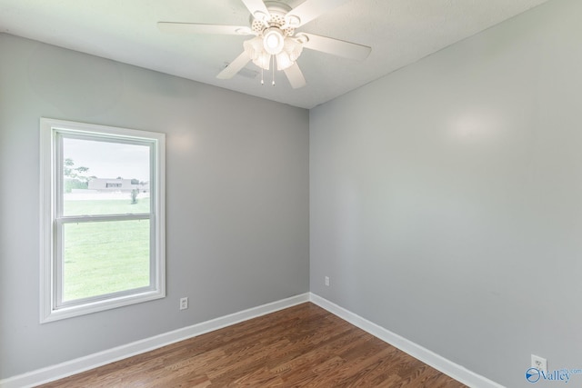 11228 Stewart Rd, Tanner, AL 35671 - empty room featuring plenty of natural light, dark wood-style floors, baseboards, and a ceiling fan