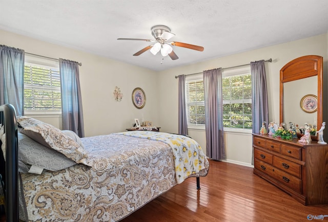 bedroom with baseboards, a ceiling fan, and wood finished floors