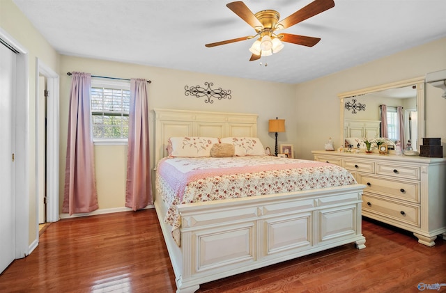 bedroom featuring ceiling fan, baseboards, and dark wood-style flooring