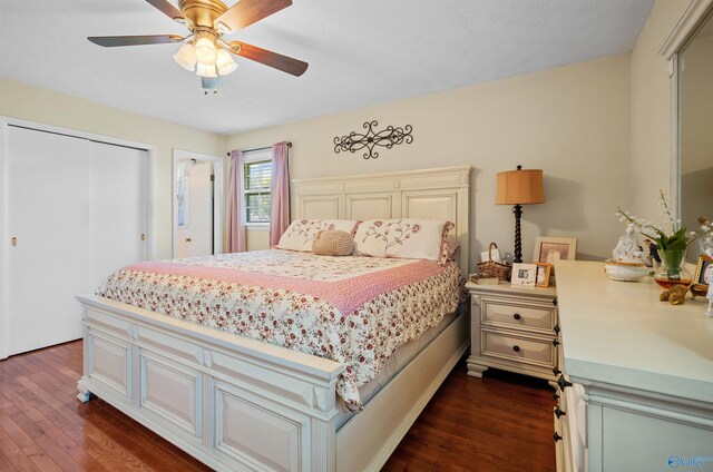 bedroom with dark wood-style floors, a closet, and ceiling fan