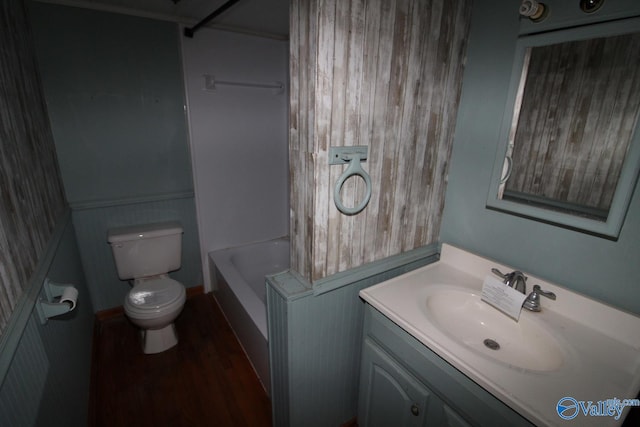 full bathroom with vanity, toilet, hardwood / wood-style floors, and shower / bathing tub combination