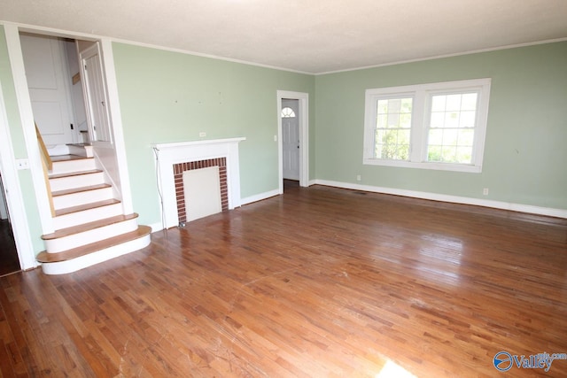 unfurnished living room with hardwood / wood-style floors, a fireplace, and crown molding