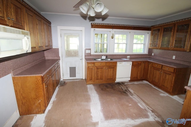 kitchen with light wood-type flooring, white appliances, ornamental molding, and sink