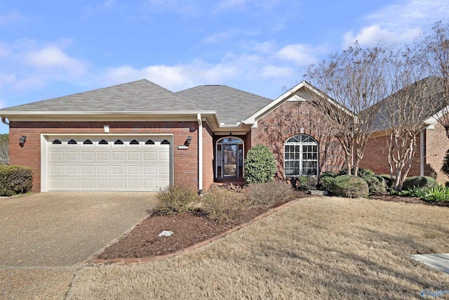 ranch-style home featuring a garage, roof with shingles, concrete driveway, and brick siding