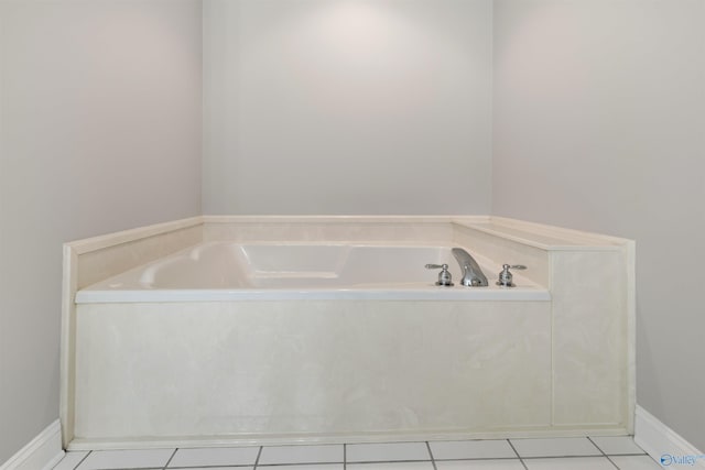 full bathroom with tile patterned flooring, a garden tub, and baseboards