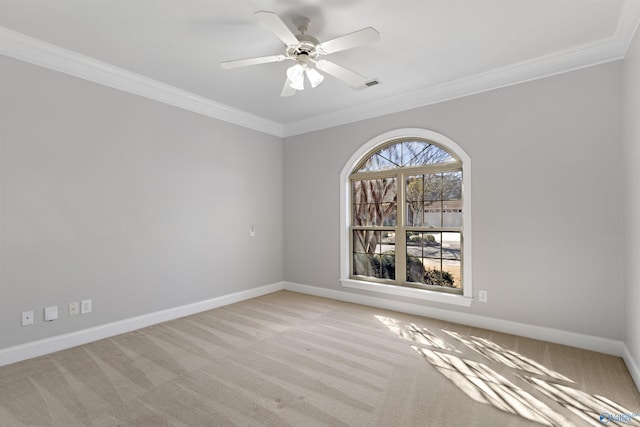 empty room featuring visible vents, crown molding, light carpet, and baseboards