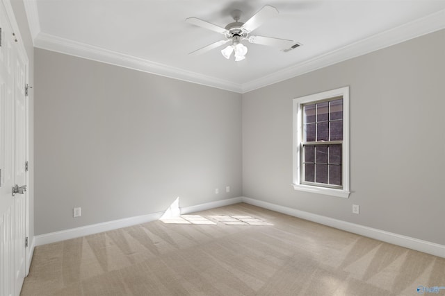 unfurnished room featuring a ceiling fan, light carpet, crown molding, and baseboards