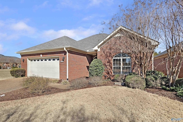 ranch-style home featuring a garage, brick siding, driveway, and a shingled roof