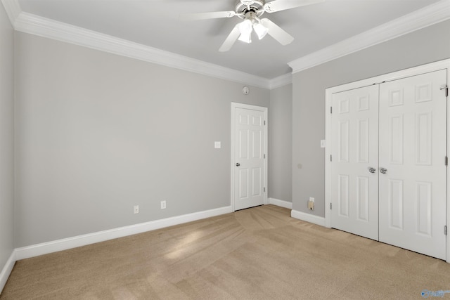 unfurnished bedroom with baseboards, ornamental molding, ceiling fan, and light colored carpet