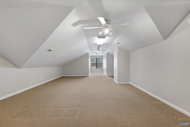 bonus room with baseboards, vaulted ceiling, a ceiling fan, and light colored carpet