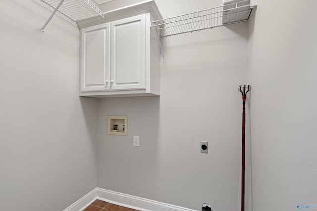 laundry area featuring hookup for a washing machine, cabinet space, electric dryer hookup, and baseboards