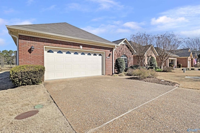 ranch-style home featuring a garage, concrete driveway, brick siding, and roof with shingles