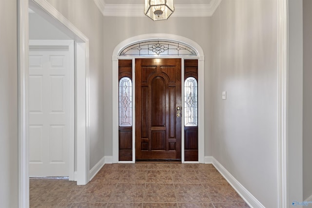 foyer featuring tile patterned flooring, crown molding, and baseboards