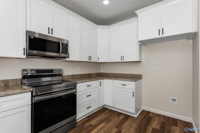 4452 Sibert St S, Gadsden, AL 35903 - kitchen featuring stainless steel appliances, dark wood finished floors, white cabinets, and a textured ceiling