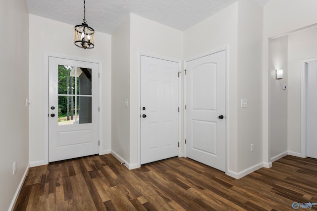 4452 Sibert St S, Gadsden, AL 35903 - foyer with dark wood-type flooring, a chandelier, and a textured ceiling