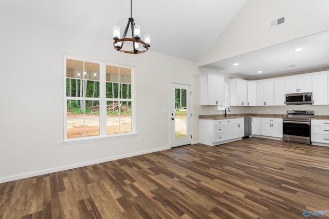 4452 Sibert St S, Gadsden, AL 35903 - kitchen featuring appliances with stainless steel finishes, a chandelier, dark wood finished floors, white cabinetry, and hanging light fixtures