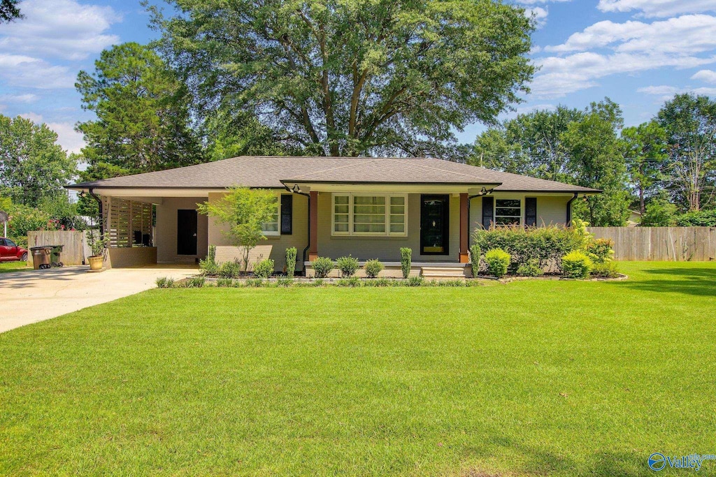 ranch-style home with a front yard and a carport