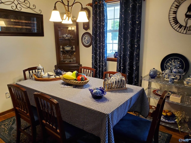 dining space featuring an inviting chandelier and wood-type flooring