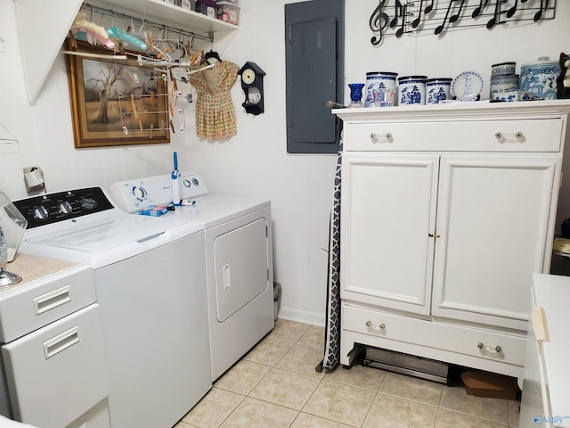washroom with cabinets, washing machine and dryer, light tile patterned floors, and electric panel