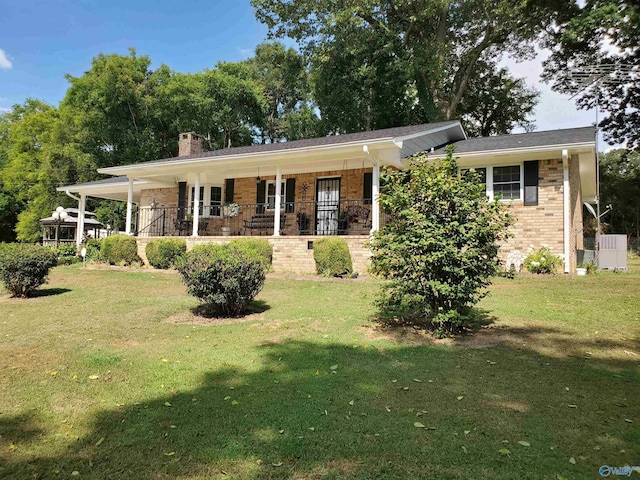 ranch-style home with covered porch and a front yard