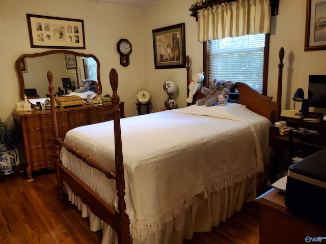 bedroom with dark hardwood / wood-style floors