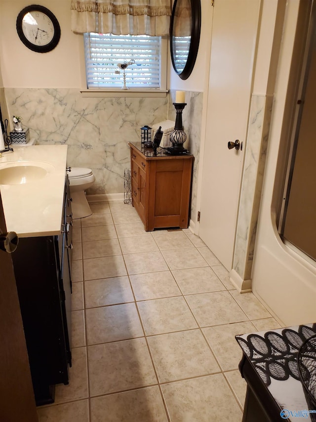 full bathroom featuring vanity, tile patterned floors, toilet, and shower / washtub combination