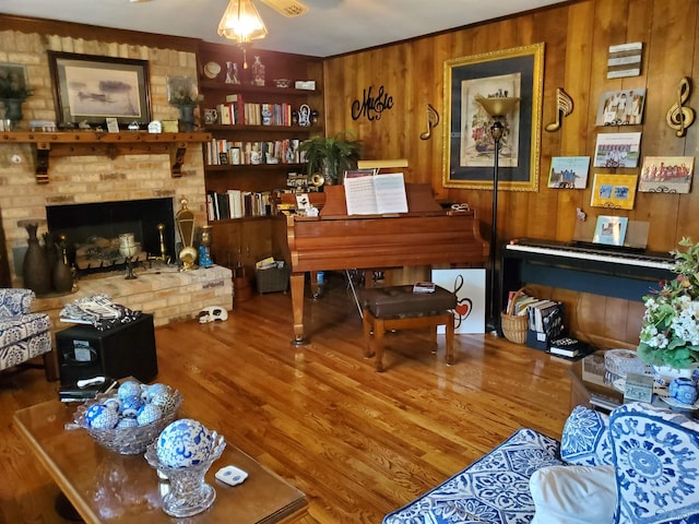 living area featuring a fireplace, wood-type flooring, and wooden walls