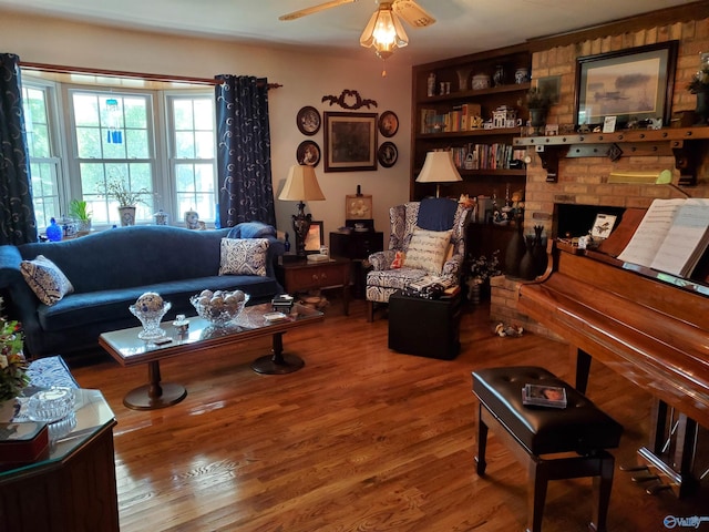 living room featuring hardwood / wood-style flooring, a fireplace, and ceiling fan