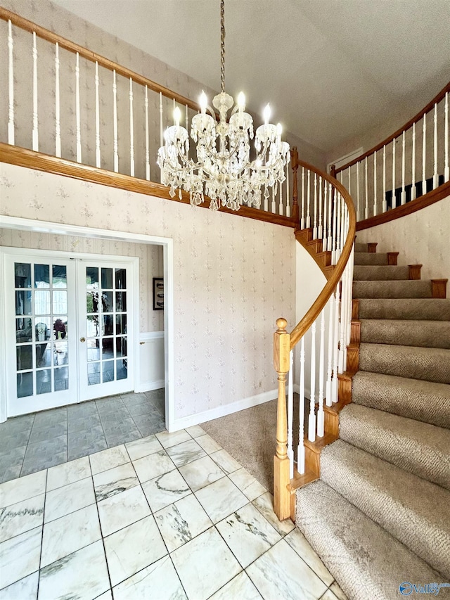 interior space with french doors, stairway, a chandelier, baseboards, and wallpapered walls