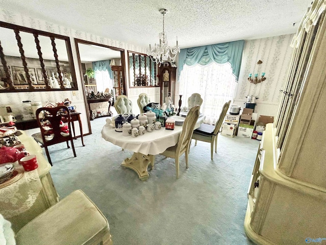 carpeted dining room with a notable chandelier and a textured ceiling