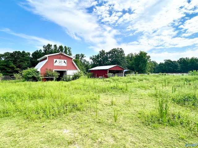 view of yard featuring an outbuilding and a rural view