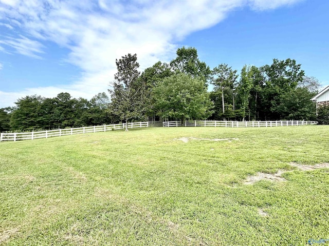 view of yard with a rural view and fence