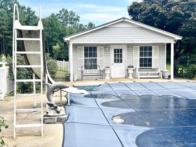 exterior space featuring covered porch, fence, and a fenced in pool